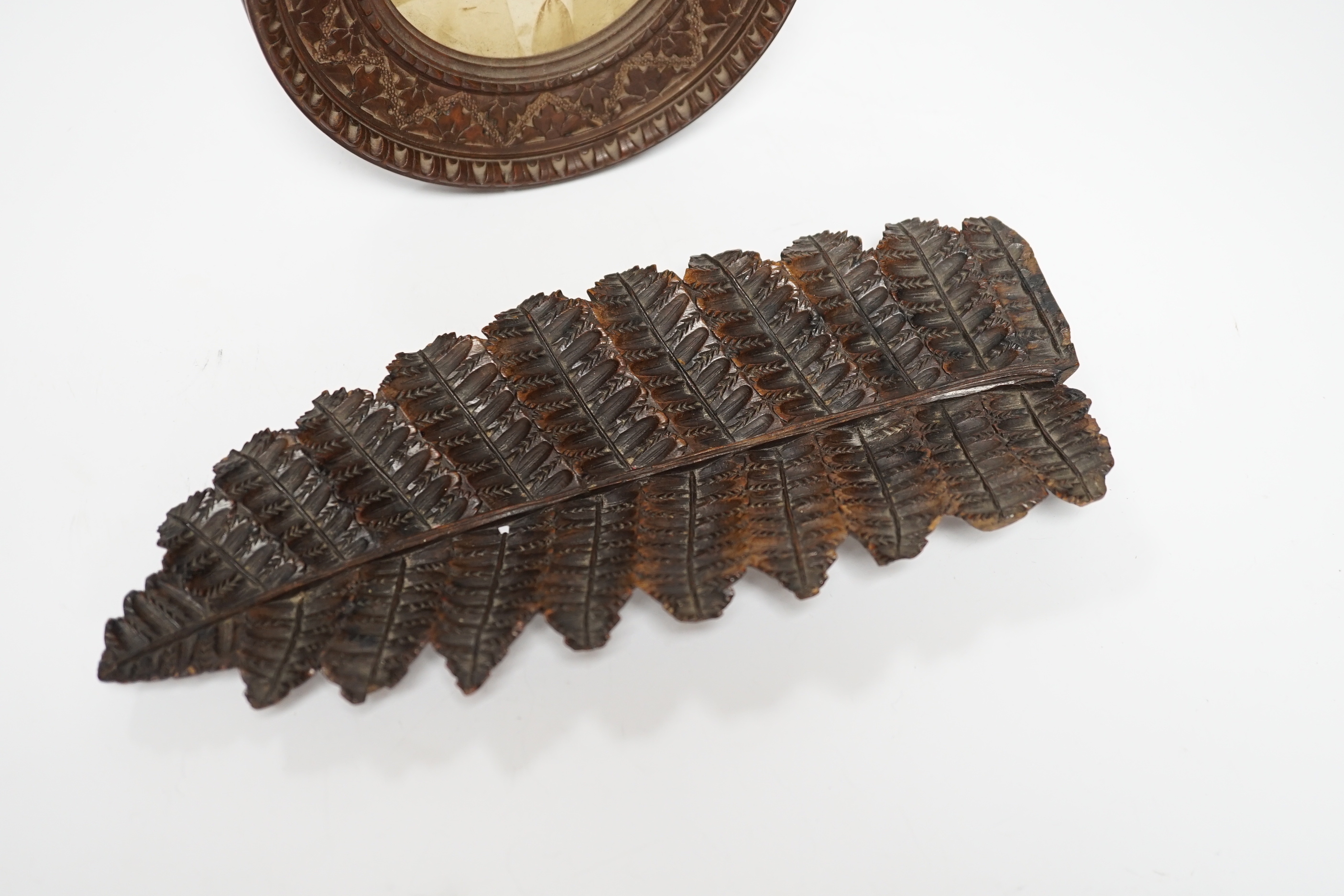 A Victorian carved wood photo frame and fern leaf dish, leaf dish 25c long